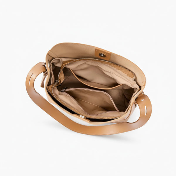 Amara Vegan Leather Bucket Bag in brown, top view of interior showing zip divider, slip pockets, and magnetic snap closure
