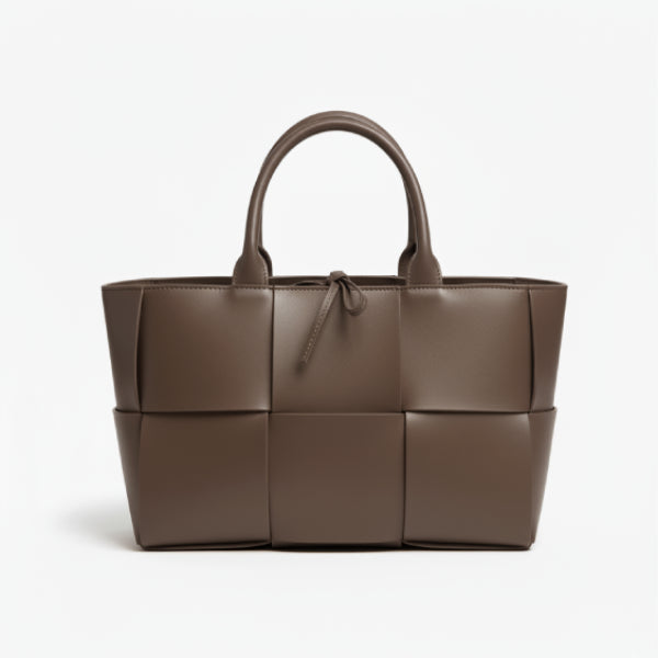 Front view of Aurelia brown genuine leather tote bag with woven texture, leather handles, and a tie closure