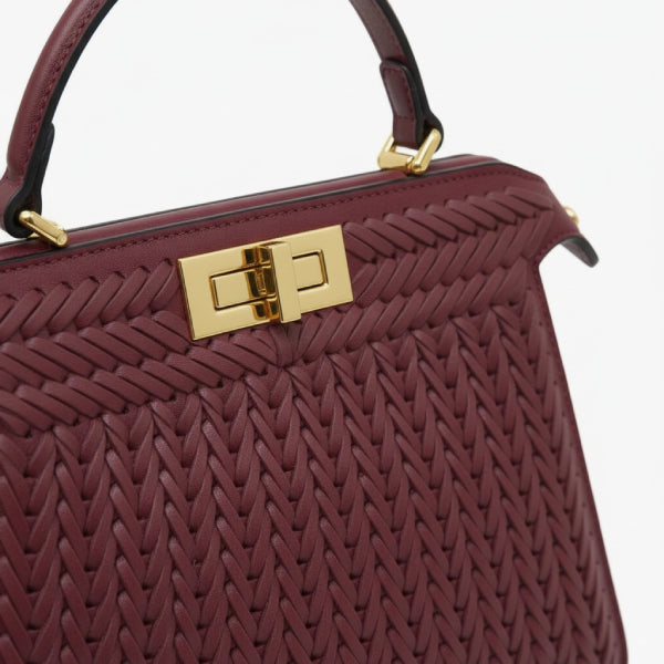 Close-up of Aurora vegan leather satchel bag in wine red with gold clasp