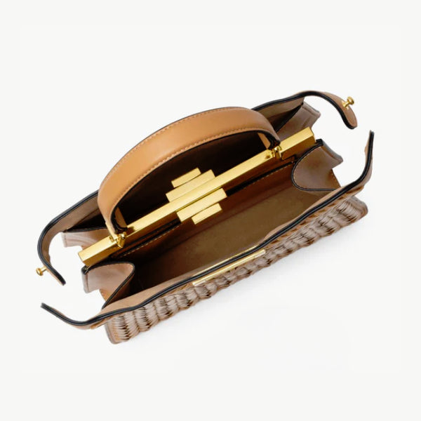 Interior view of brown vegan leather satchel bag showing the spacious compartment and gold clasp closure