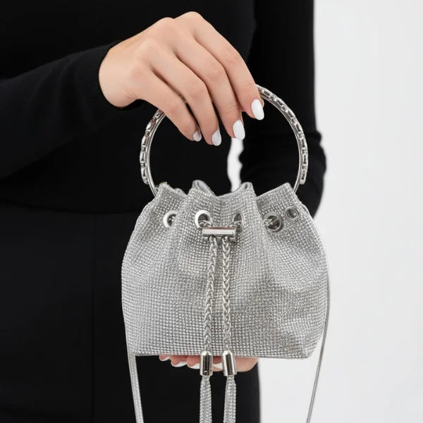 Aveline Rhinestone Crystal Evening Bag in silver, lifestyle closeup on model highlighting circular handle, chain strap, and glittering crystals