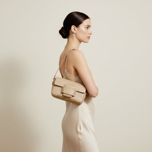 Faelina genuine cowhide shoulder bag in apricot worn by model with a sleek, elegant design