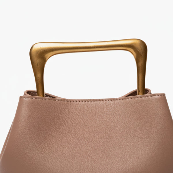 Izelia Genuine Leather Crossbody Bag in apricot, closeup highlighting sculptural square metal handle and smooth pebbled leather