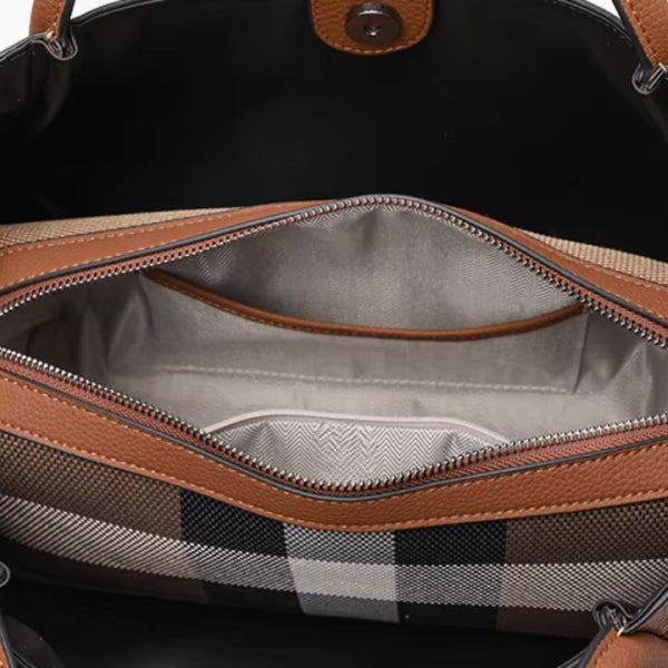 Interior view of a brown canvas and leather tote bag with a beige fabric lining
