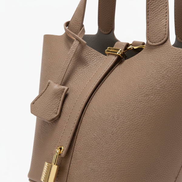 Lunelia Vegan Leather Bucket Bag in brown, closeup highlighting pebbled texture, gold hardware, and structured twin handles