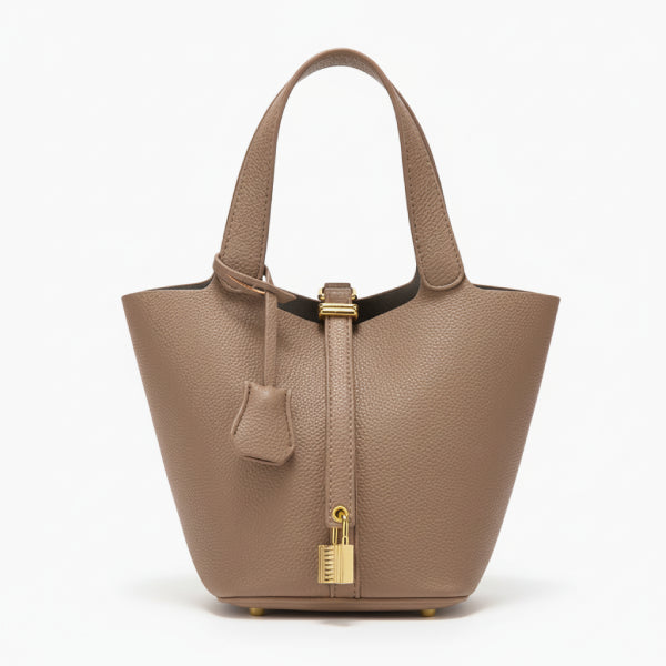 Lunelia Vegan Leather Bucket Bag in brown, front studio view showcasing tapered bucket silhouette, gold padlock charm, and base feet
