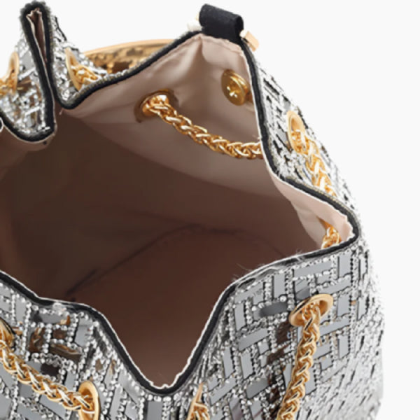 Lyanna Metallic Embellished Bucket Bag in silver, top view of satin-lined interior with gold chain drawstring and snap closure
