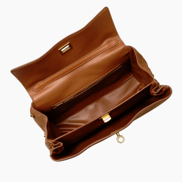 Inside view of brown velvet satchel bag with zip pocket and gold hardware clasp