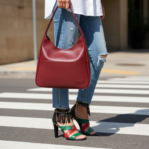 Model wearing Seliora vegan leather shoulder bag in wine red color with casual chic outfit and sandals