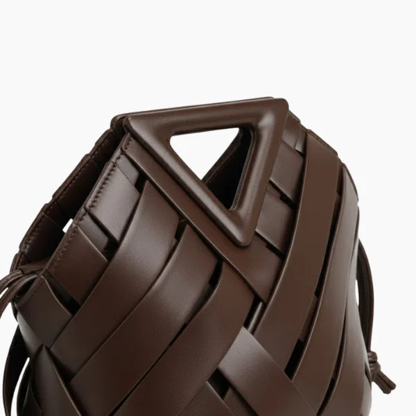 Seren Vegan Leather Bucket Bag in dark brown, closeup highlighting triangular top handle and wide woven straps