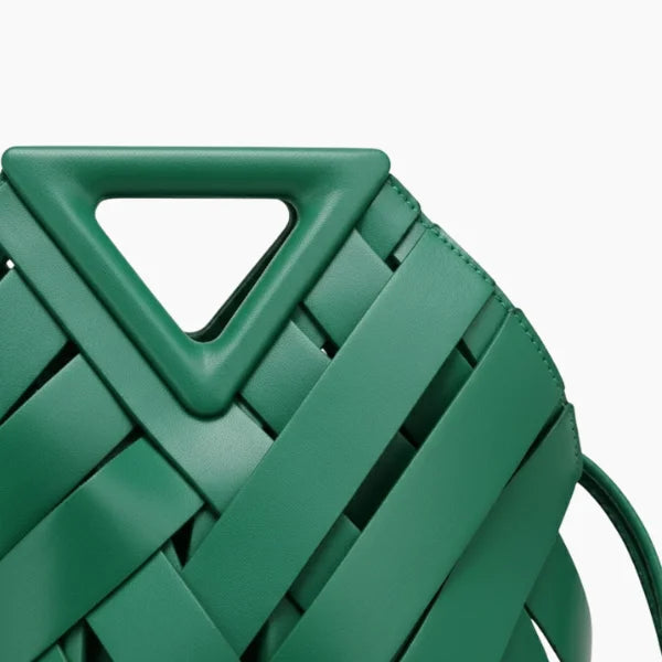 Seren Vegan Leather Bucket Bag in green, closeup highlighting triangular top handle and wide woven straps