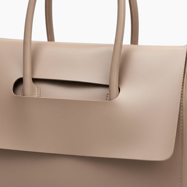 Close-up of the Sylvene vegan leather tote bag handle in a soft khaki color, highlighting its sleek and minimalistic design