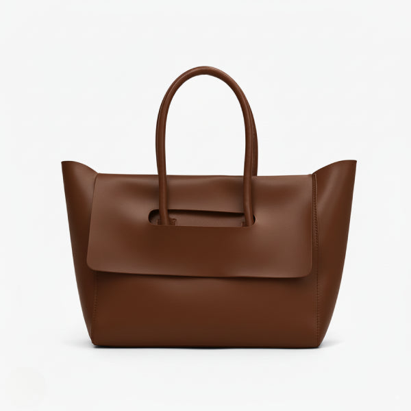 Front view of brown vegan leather tote bag featuring a contemporary shape with a flap closure and clean lines for a modern aesthetic