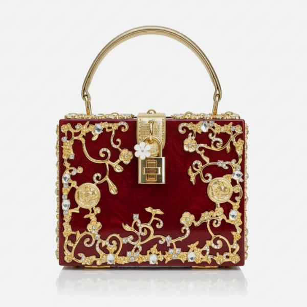 Front view of Zephyra acrylic evening bag in red with gold floral design and lock closure