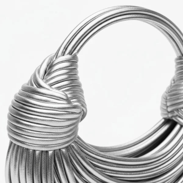 Zyra Vegan Leather Evening Bag in silver, closeup of knotted handle detail and wrapped cord workmanship