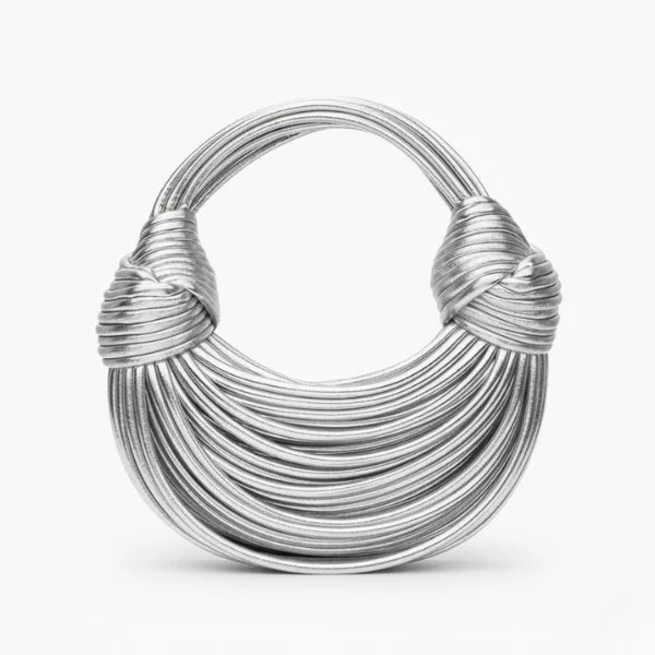 Zyra Vegan Leather Evening Bag in silver, front studio view showcasing crescent silhouette with layered cord texture and knotted handles