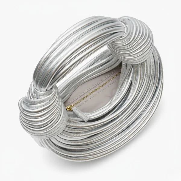 Zyra Vegan Leather Evening Bag in silver, top view of main compartment with zipper closure framed by sculptural round handles