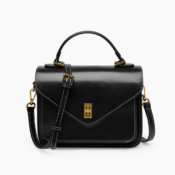 Front view of the black genuine leather satchel bag with a gold-tone clasp, offering a structured design and versatile style for any occasion