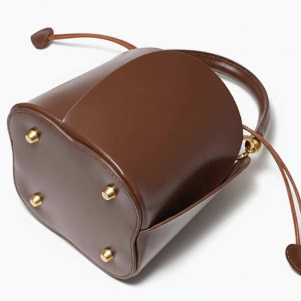 Althea Vegan Leather Bucket Bag in brown, bottom view highlighting structured base and four gold metal feet