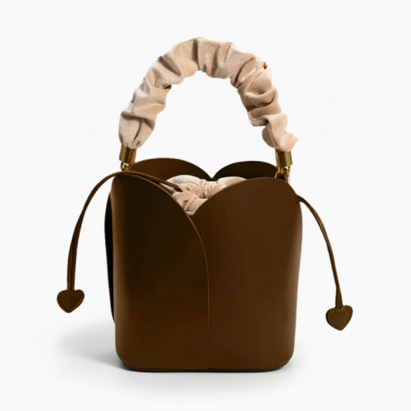 Althea Vegan Leather Bucket Bag in brown, front studio view showcasing tulip-inspired silhouette, ruched handle, and heart-tipped drawstrings