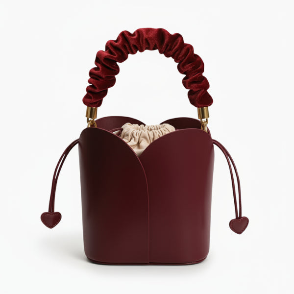 Althea Vegan Leather Bucket Bag in wine red, front studio view showcasing tulip-inspired silhouette with ruched handle and heart pulls