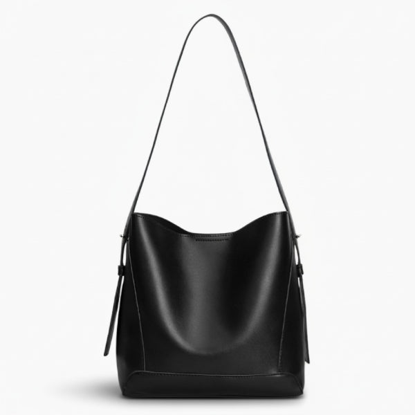 Amara Vegan Leather Bucket Bag in black, front studio view highlighting clean bucket silhouette and long shoulder strap