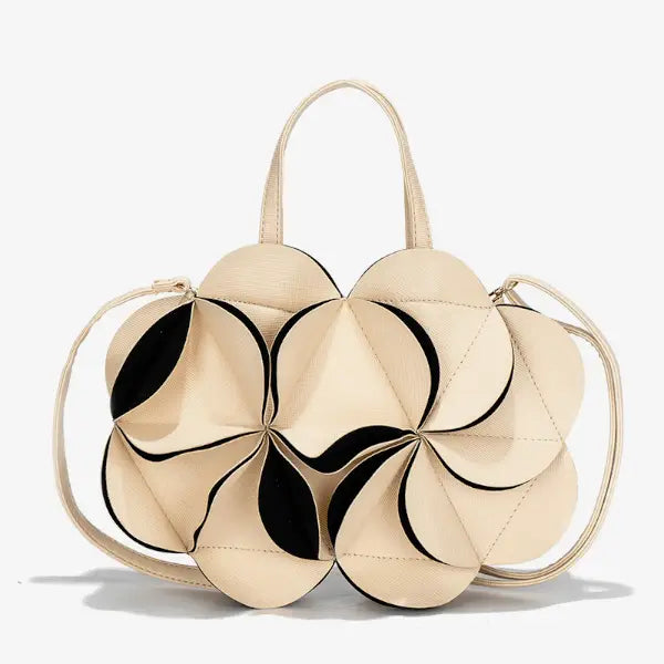 Front view of a beige vegan leather evening bag with a flower-shaped design, black accents, and two top handles
