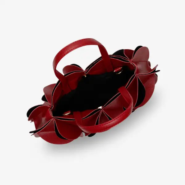 Interior view of a red vegan leather evening bag with a spacious compartment and black lining