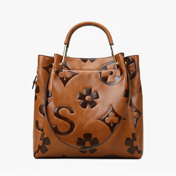 Front view of Amora embossed vegan leather tote bag in brown with embossed floral patterns and sleek design