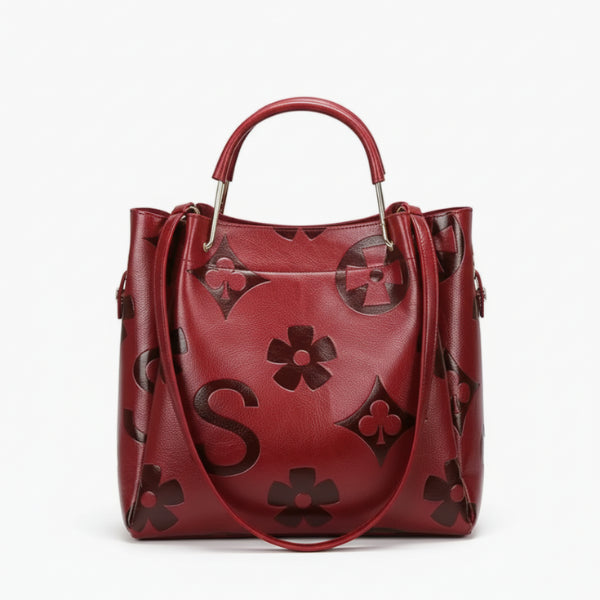 Front view of Amora embossed vegan leather tote bag in wine red with embossed floral patterns and sleek design