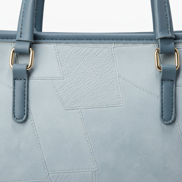 Close-up of the Anelisse vegan leather tote bag in blue, highlighting its textured surface and gold-tone accents