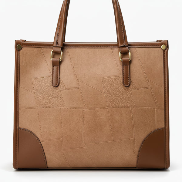 Close-up of the Anelisse vegan leather tote bag in brown, highlighting the geometric pattern and leather texture with gold hardware