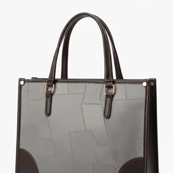 Close-up of the Anelisse vegan leather tote bag in grey, highlighting the geometric pattern and leather texture with contrasting brown details