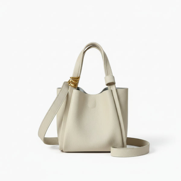 Arden Genuine Leather Bucket Bag in off-white, front studio view highlighting compact bucket silhouette with top handles and crossbody strap