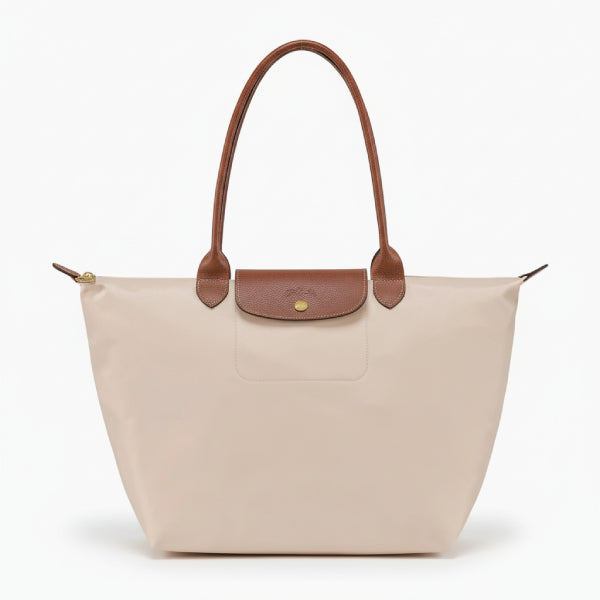 Front view of Aria beige vegan leather tote bag with brown leather handles and a minimalist flap design