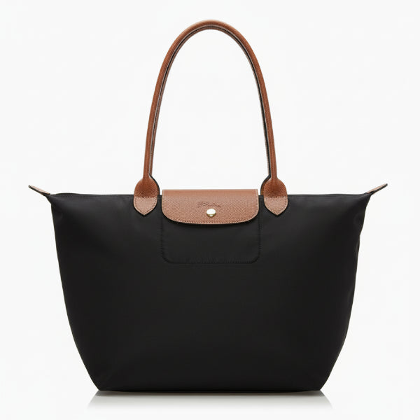 Front view of Aria black vegan leather tote bag with brown leather handles and a minimalist flap design