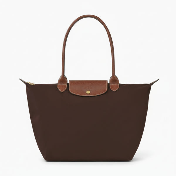 Front view of Aria brown vegan leather tote bag with brown leather handles and a minimalist flap design