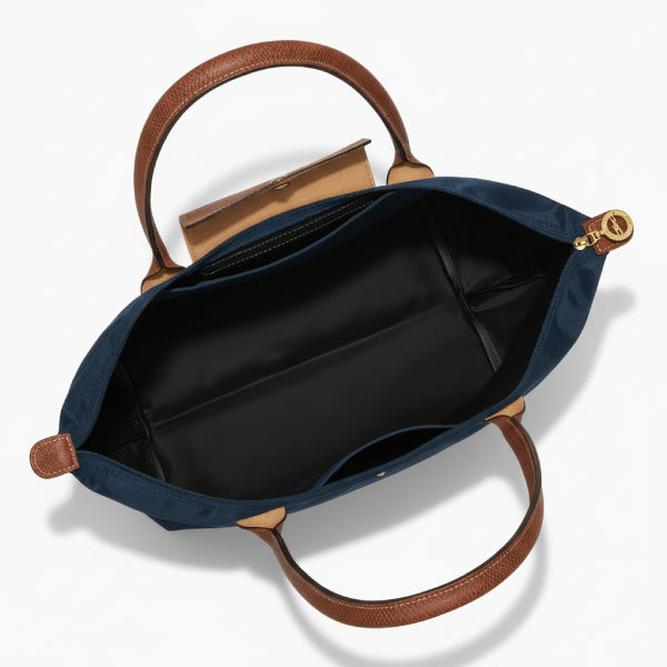 Interior view of Aria navy blue vegan leather tote bag showing spacious black lining and zipper closure