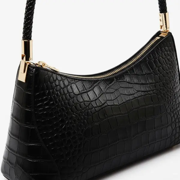 Close-up of the black genuine cowhide leather shoulder bag, highlighting the fine stitching and gold-tone hardware that complements its luxurious design