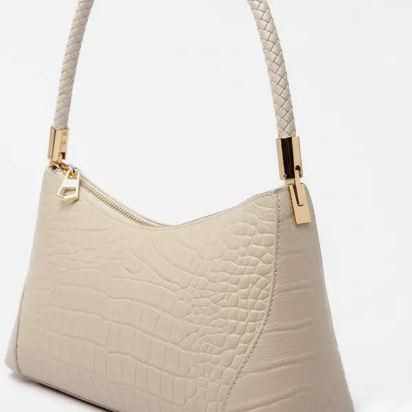 Close-up of the Arlena genuine cowhide shoulder bag in off-white, highlighting its textured leather surface and gold hardware accents