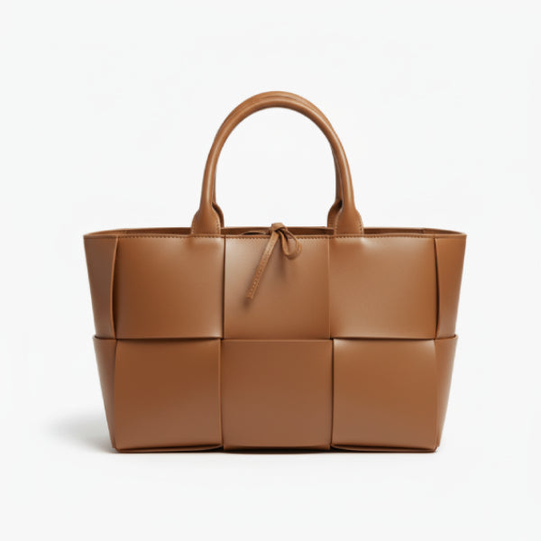 Front view of Aurelia caramel genuine leather tote bag with woven texture, leather handles, and tie closure