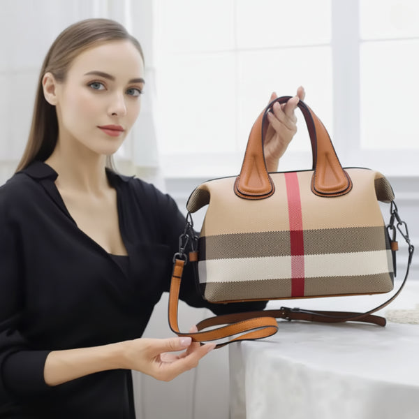 Close-up shot of a woman holding a brown vegan leather tote bag with adjustable shoulder straps, showcasing its premium quality and design