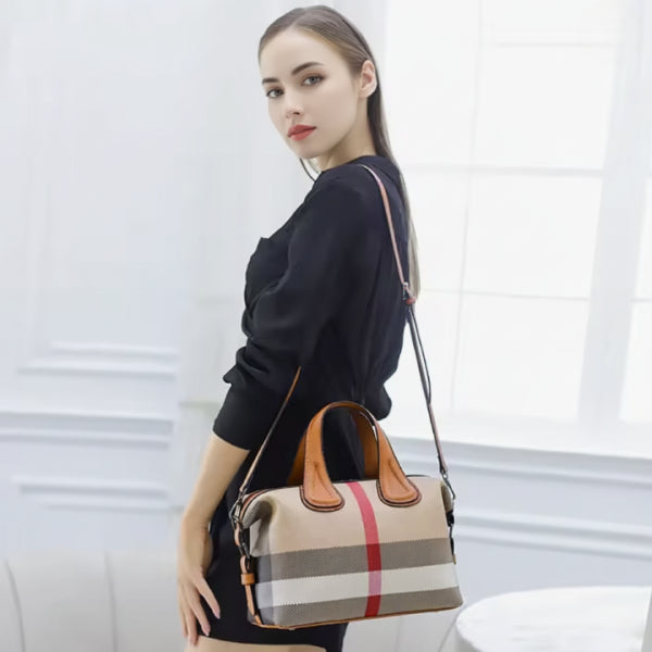 Side view of a woman holding a stylish brown vegan leather tote bag with a simple and elegant design, featuring sleek shoulder straps