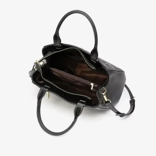 Interior of Azura black leather satchel bag showing spacious compartments with a light fabric lining