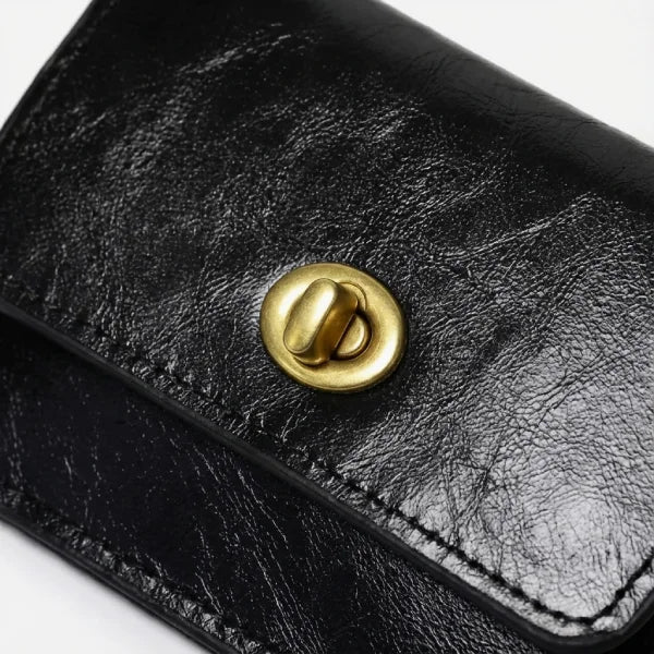 Black leather wallet with a gold clasp on a white background