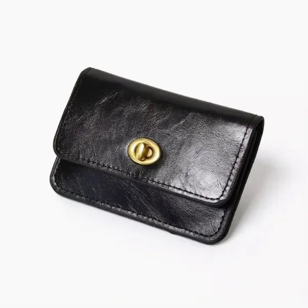 Black leather wallet with a gold button on a white background