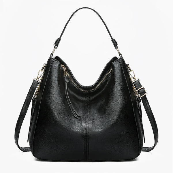 Front view of black vegan leather shoulder bag with a sleek design and gold zipper accents