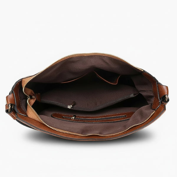 Inside view of brown vegan leather shoulder bag showing spacious compartments and zipper pocket