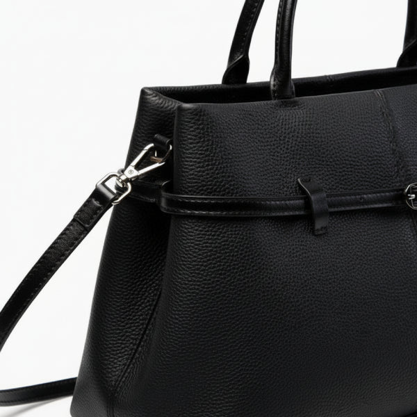 Close-up of the black genuine leather tote bag featuring a stylish buckle design and high-quality stitching with a detachable shoulder strap