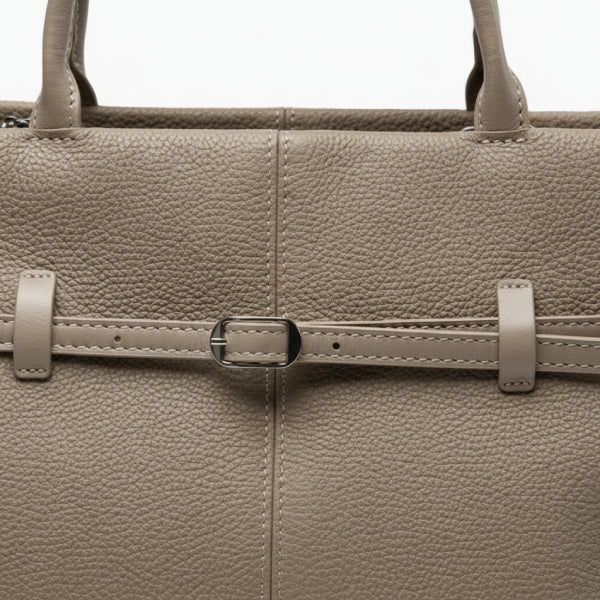 Close-up of the khaki genuine leather tote bag showcasing the elegant buckle design and fine stitching on the leather